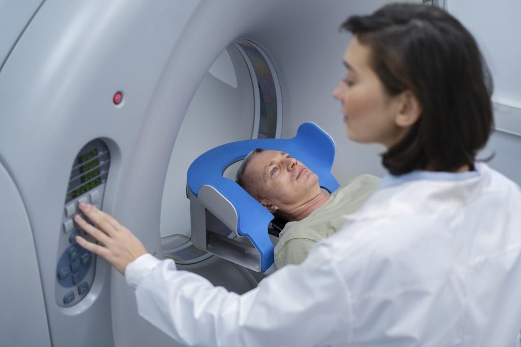 Patient preparing for a neck MRI procedure at our St. Louis clinic